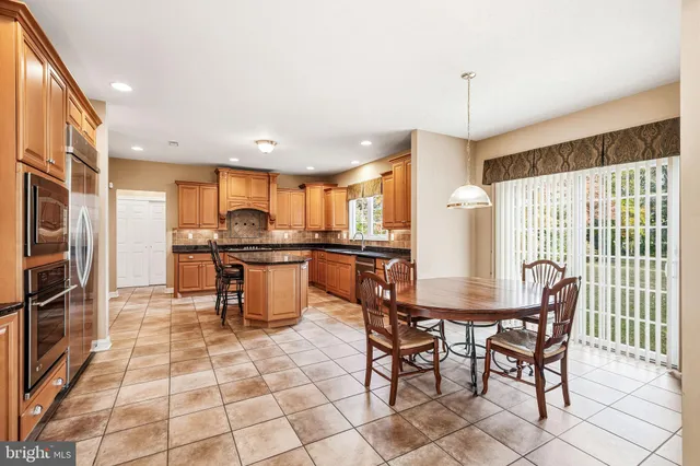 a kitchen with granite countertop sink window and stainless steel appliances