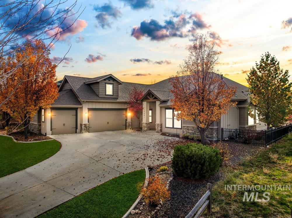 12461 North Upper Ridge Place Boise, ID 83714 - Photo 1 of 1 View of front of property with stone siding, concrete driveway, roof with shingles, and an attached garage