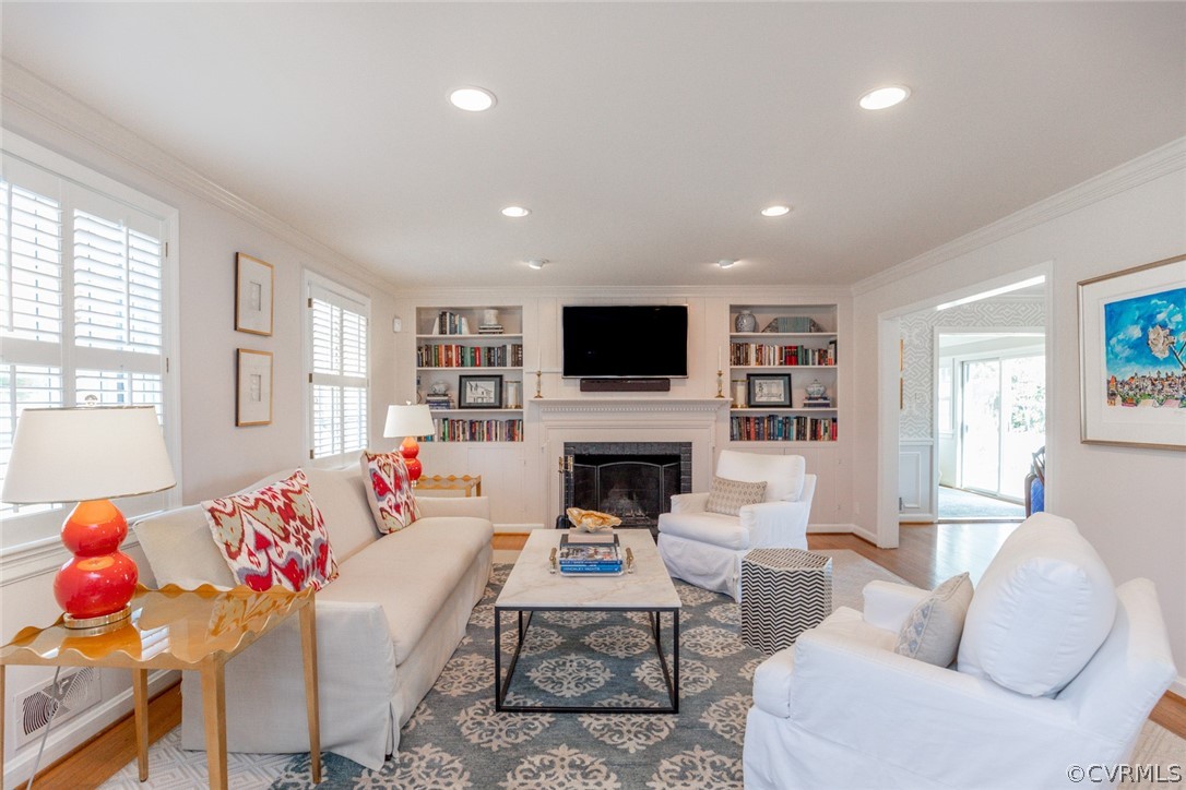 The spacious living room has two front windows wit