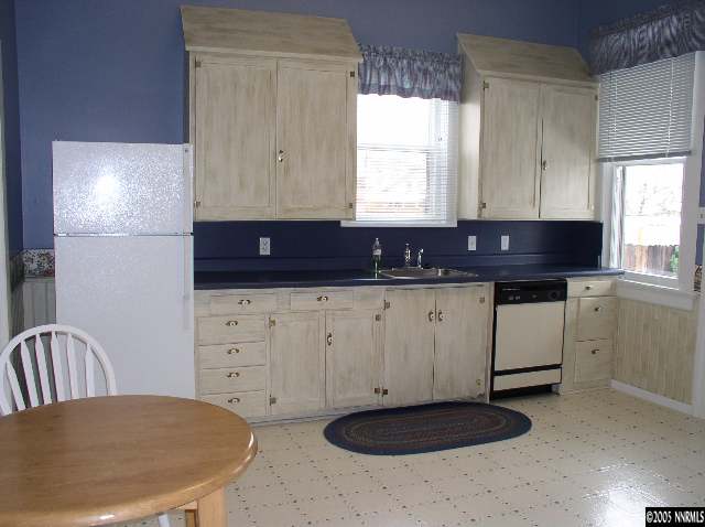 1086 Washington Street Reno, NV 89503 - Photo 3 of 4 a kitchen with a sink a stove a refrigerator and cabinets