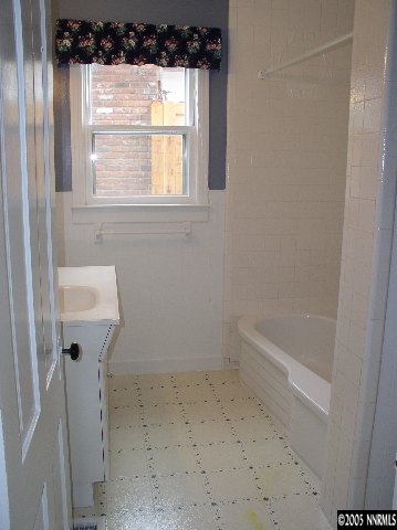 1086 Washington Street Reno, NV 89503 - Photo 4 of 4 a bathroom with a bathtub a window and a shower