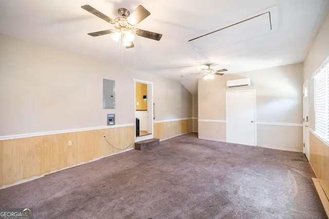 a view of a livingroom with a ceiling fan and window