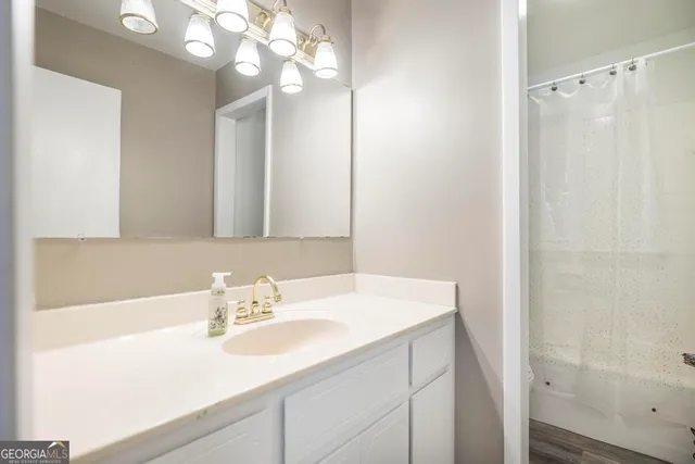 a view of a house with a backyard and a tree