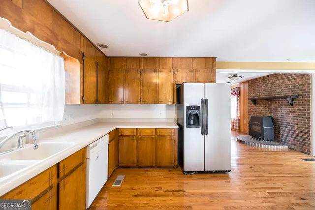 a kitchen with a refrigerator and a sink