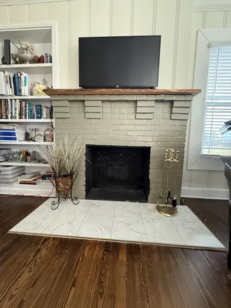 a living room with fireplace and flat screen tv