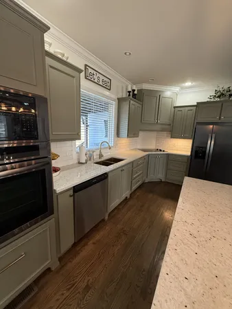 a large kitchen with a stove and a sink