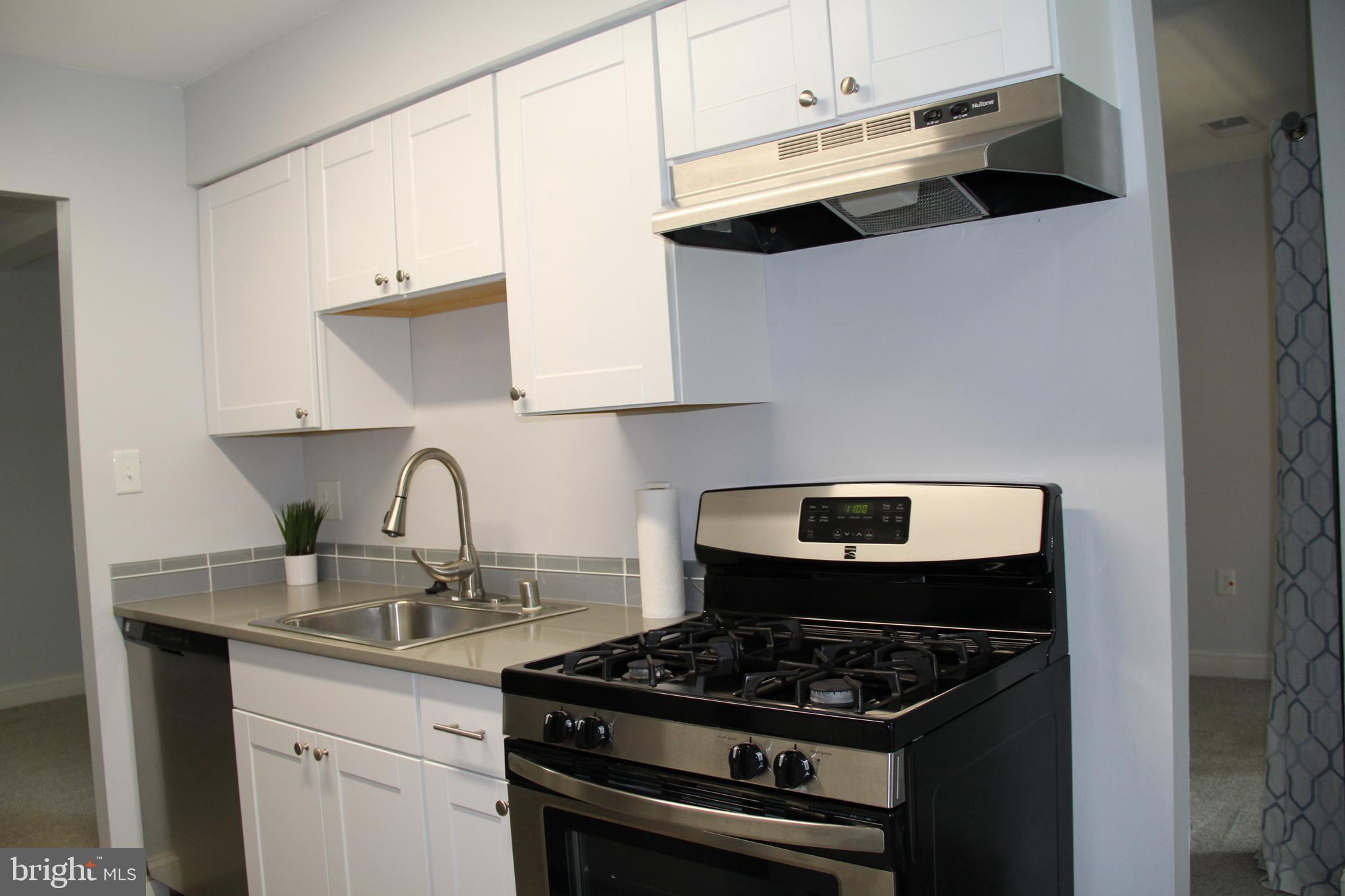 3360 Woodburn Road, Unit 23 Annandale, VA 22003 - Photo 11 of 50 a kitchen with stainless steel appliances granite countertop a sink stove and cabinets