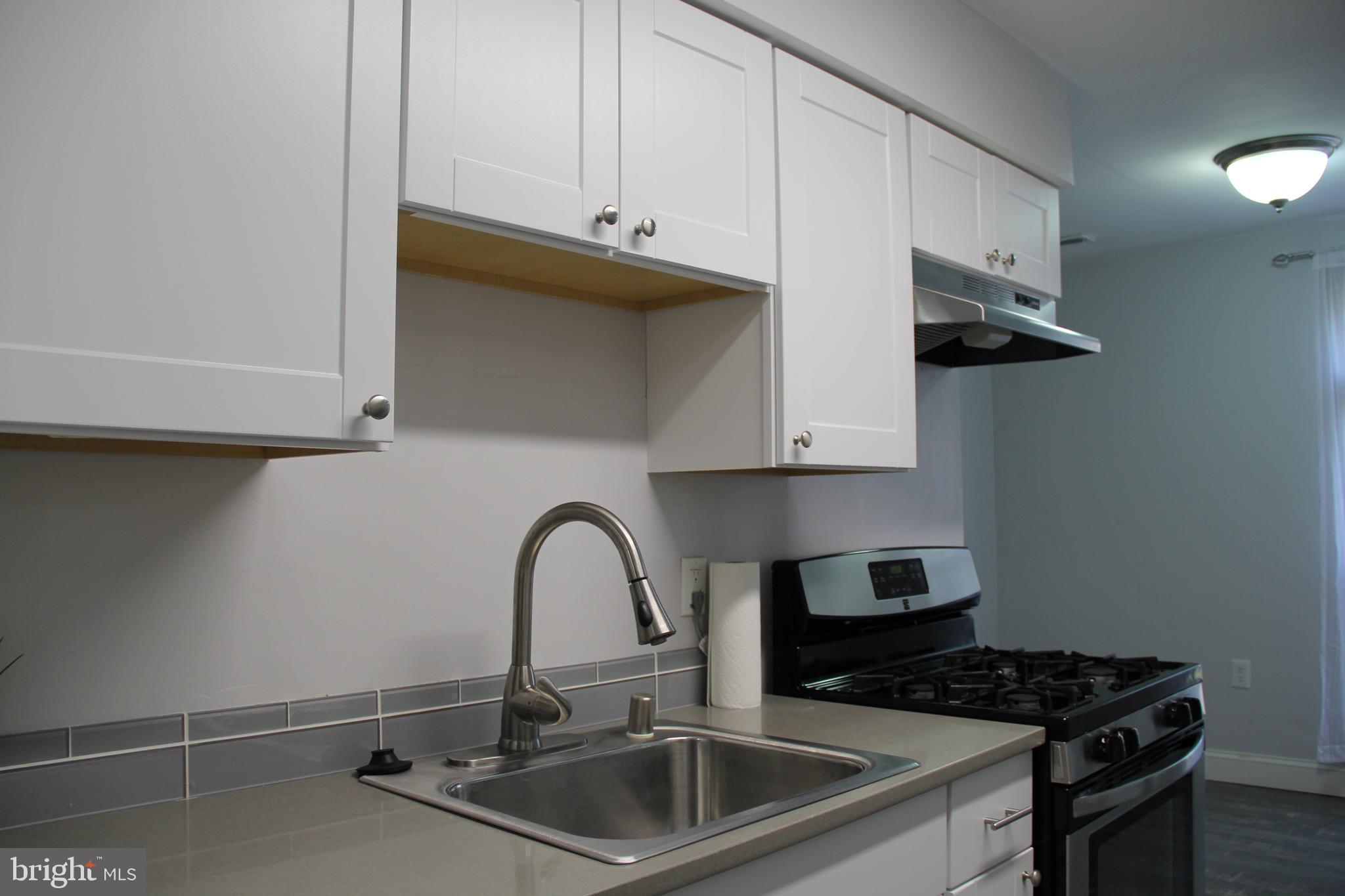 3360 Woodburn Road, Unit 23 Annandale, VA 22003 - Photo 13 of 50 a kitchen with stainless steel appliances a sink a stove and a microwave