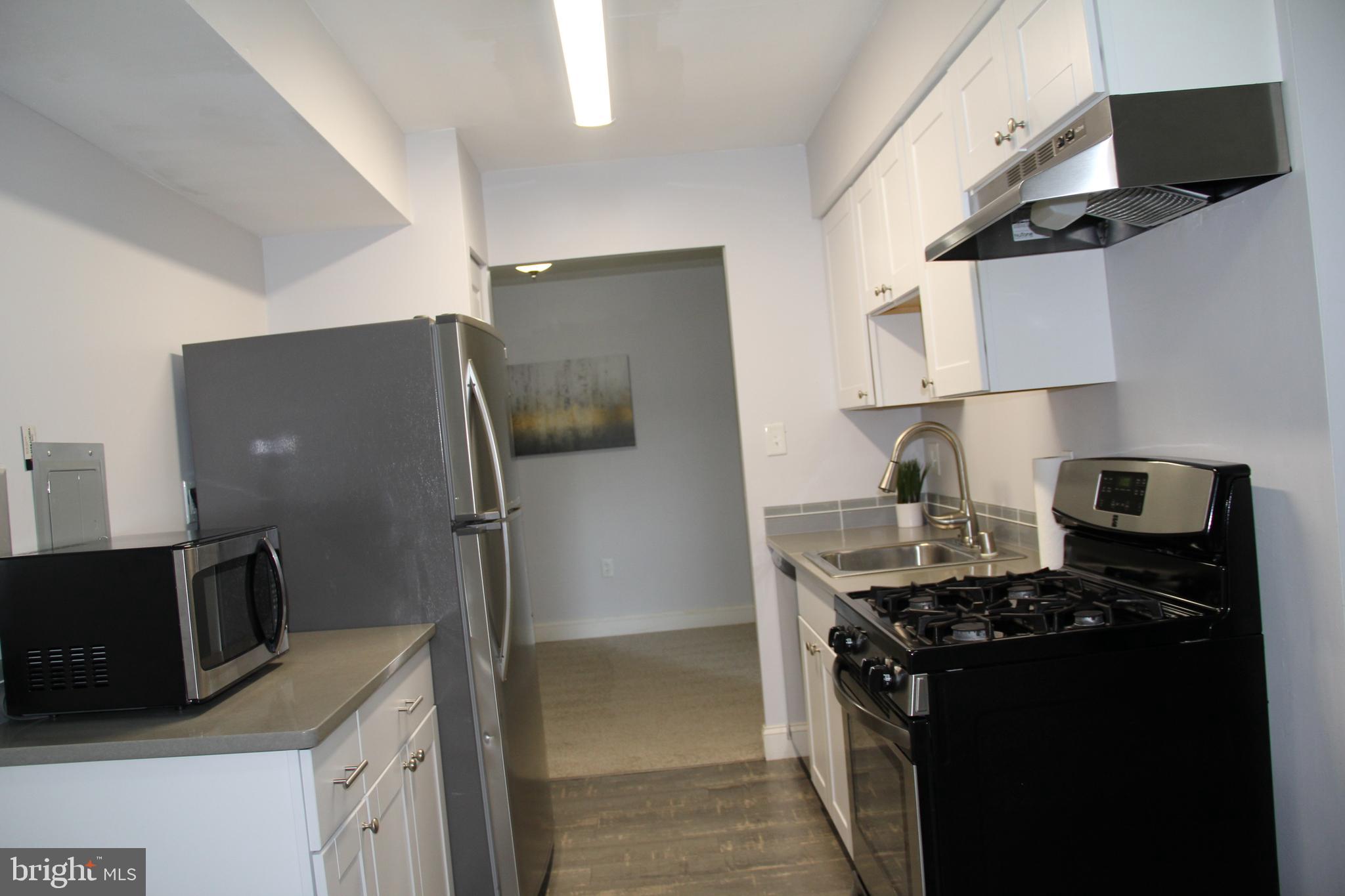 3360 Woodburn Road, Unit 23 Annandale, VA 22003 - Photo 15 of 50 a kitchen with stainless steel appliances granite countertop a refrigerator and a stove