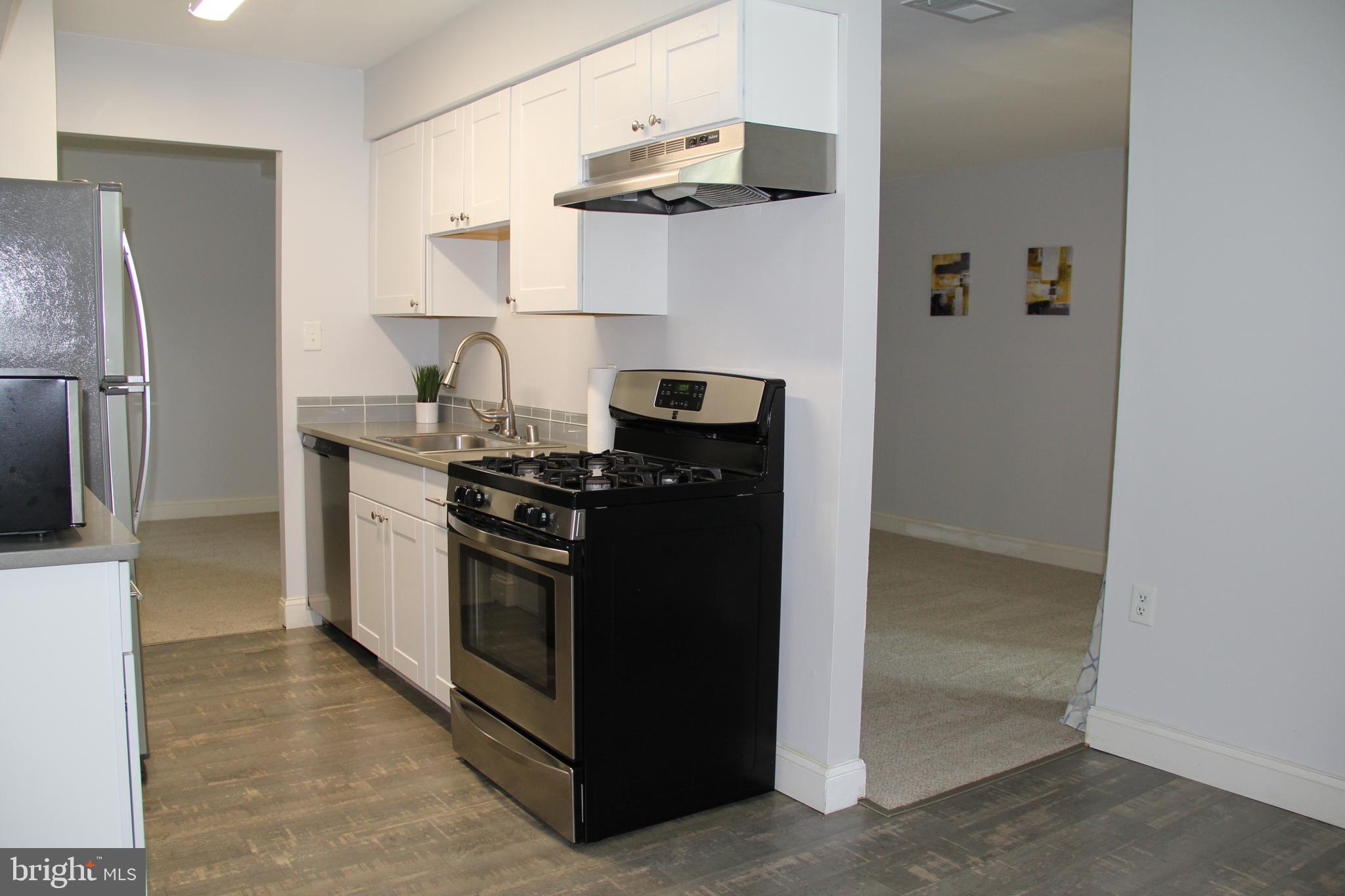 3360 Woodburn Road, Unit 23 Annandale, VA 22003 - Photo 16 of 50 a kitchen with stainless steel appliances granite countertop a refrigerator and a stove