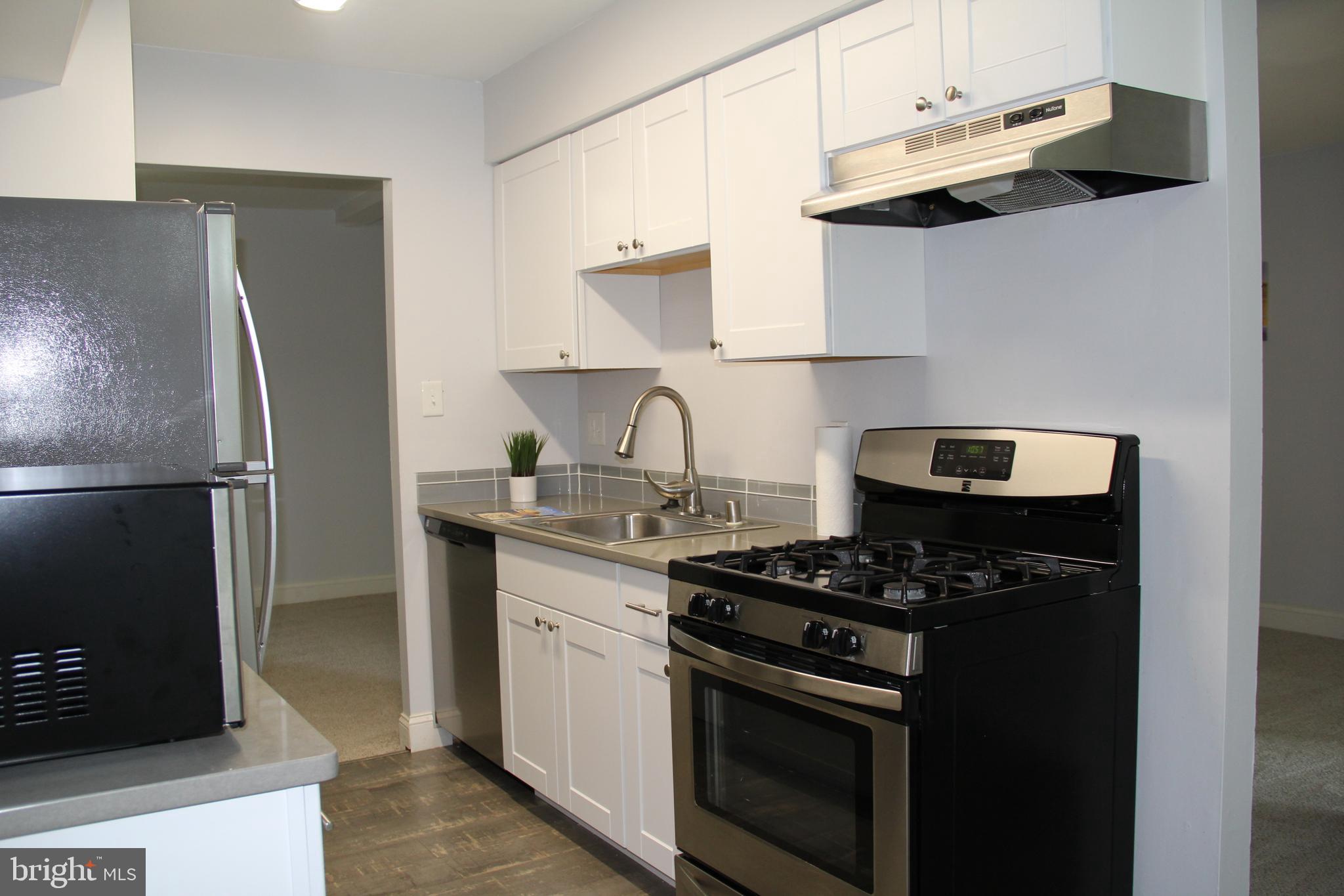 3360 Woodburn Road, Unit 23 Annandale, VA 22003 - Photo 17 of 50 a kitchen with stainless steel appliances granite countertop a stove and a refrigerator