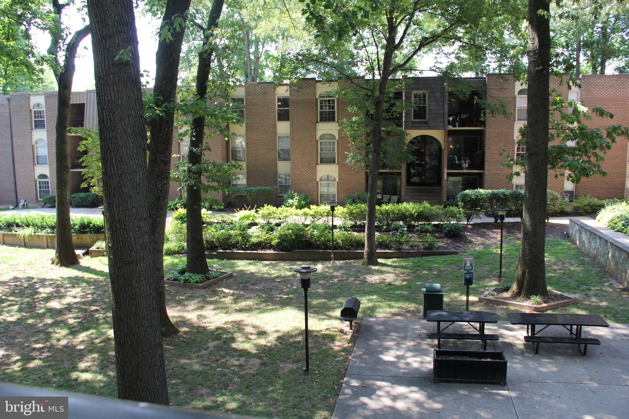 3360 Woodburn Road, Unit 23 Annandale, VA 22003 - Photo 37 of 50 a backyard of a house with lots of green space and fountain