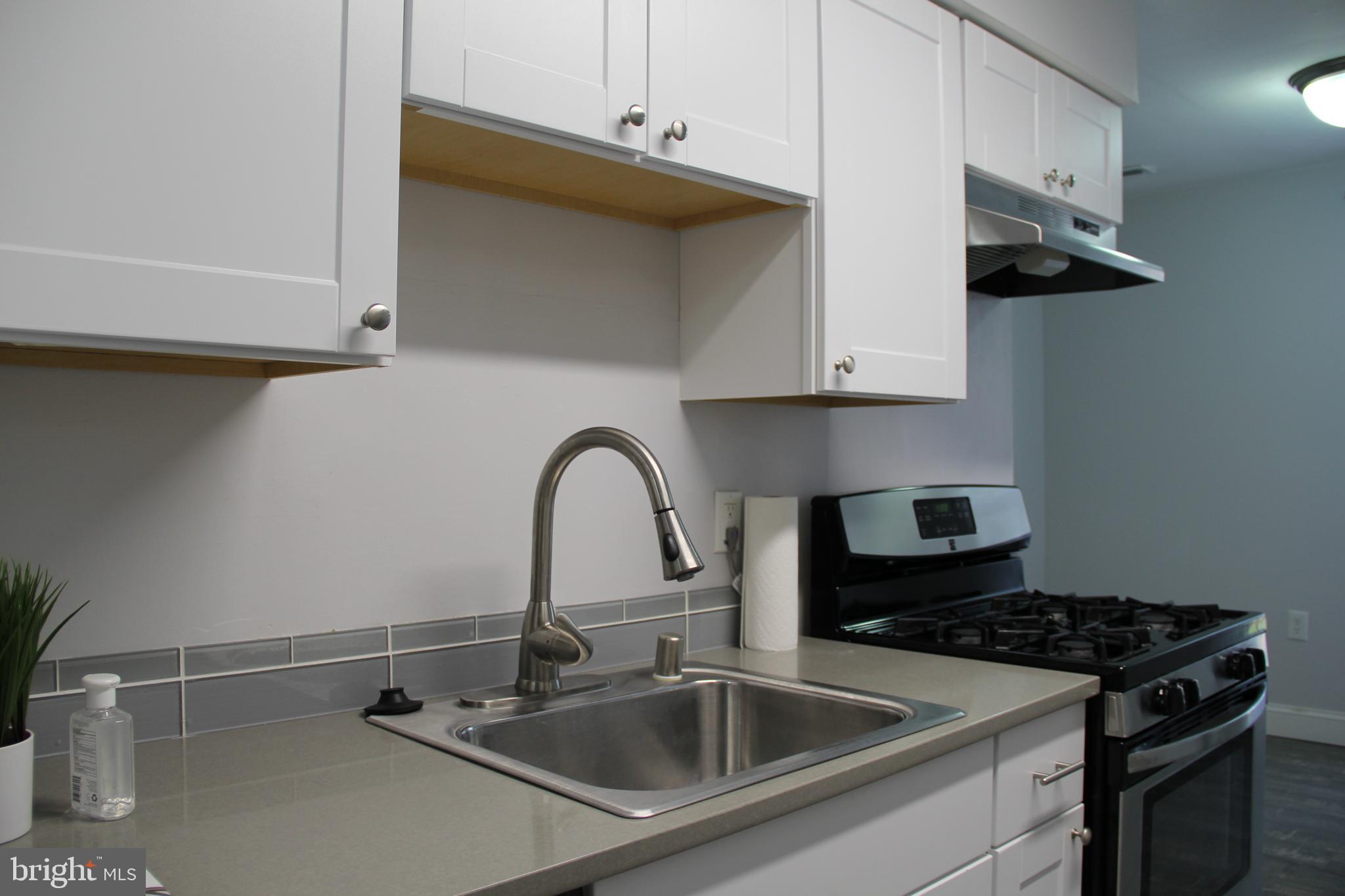 3360 Woodburn Road, Unit 23 Annandale, VA 22003 - Photo 38 of 50 a close view of a sink a counter and appliances in a kitchen
