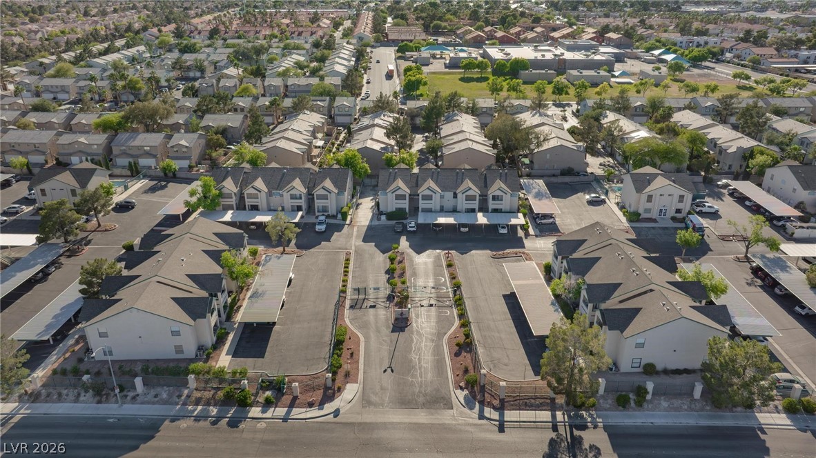 5171 South Lindell Road, Unit 103 Las Vegas, NV 89118 - Photo 21 of 24 An aerial perspective showcases a well-maintained community with abundant parking, nestled among mature trees.
