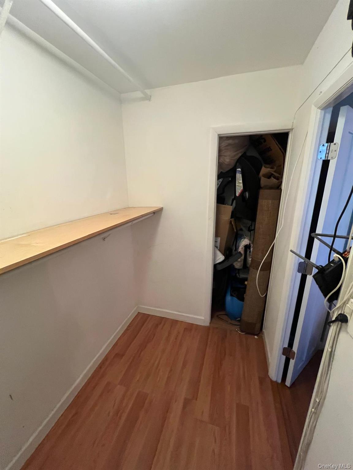 8305 98th Street, Unit 3C Queens, NY 11421 - Photo 11 of 19 a view of a room with wooden floor and closet