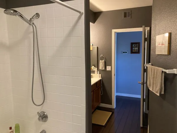 a bathroom with a glass shower door