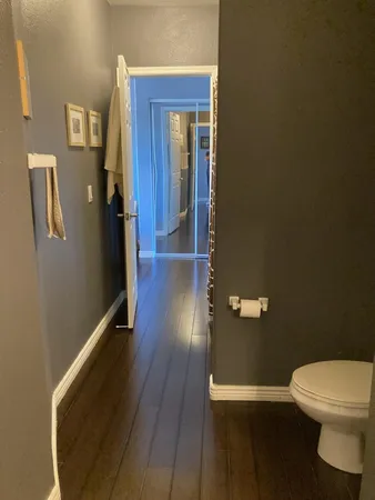 a bathroom with a toilet and a mirror