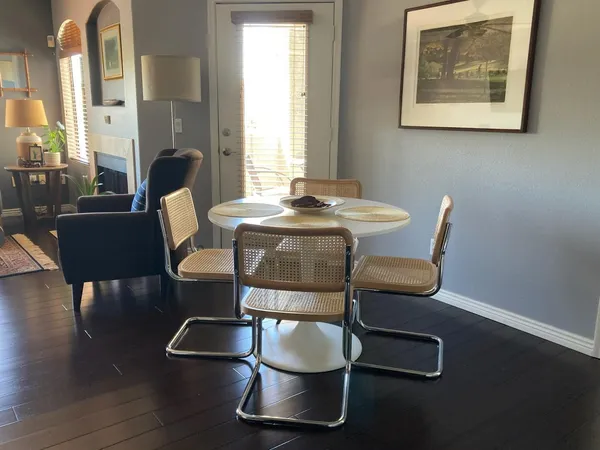 a dining room with furniture and wooden floor