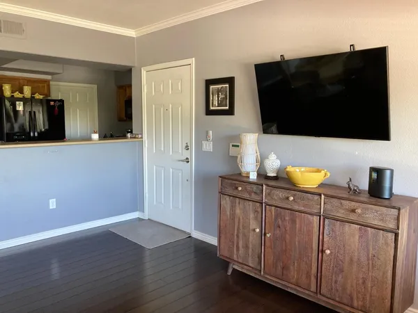 a kitchen with stainless steel appliances microwave and refrigerator