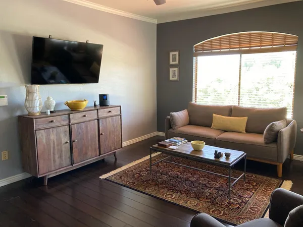 a living room with furniture and a flat screen tv