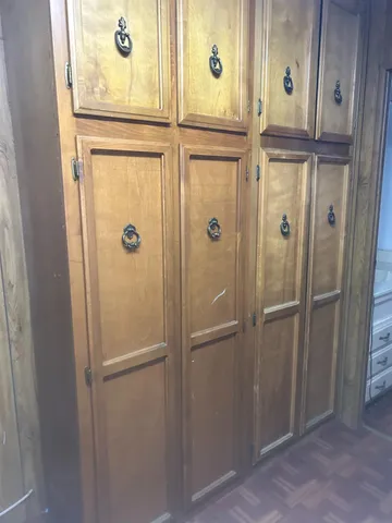 a view of an empty room with wooden floor and windows