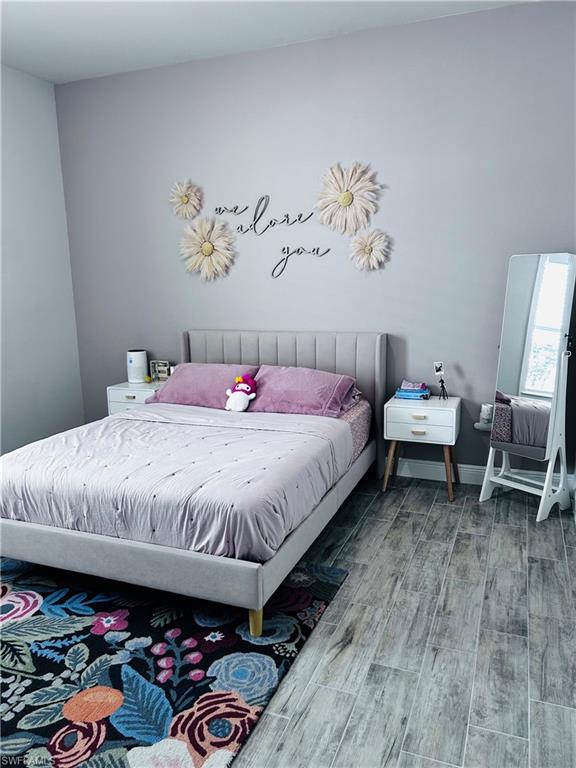 3444 Pilot Circle Naples, FL 34120 - Photo 3 of 13 a bedroom with bed and a chandelier