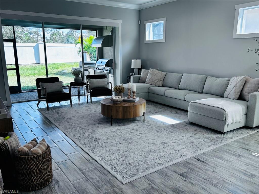 3444 Pilot Circle Naples, FL 34120 - Photo 8 of 13 a living room with furniture and a large window