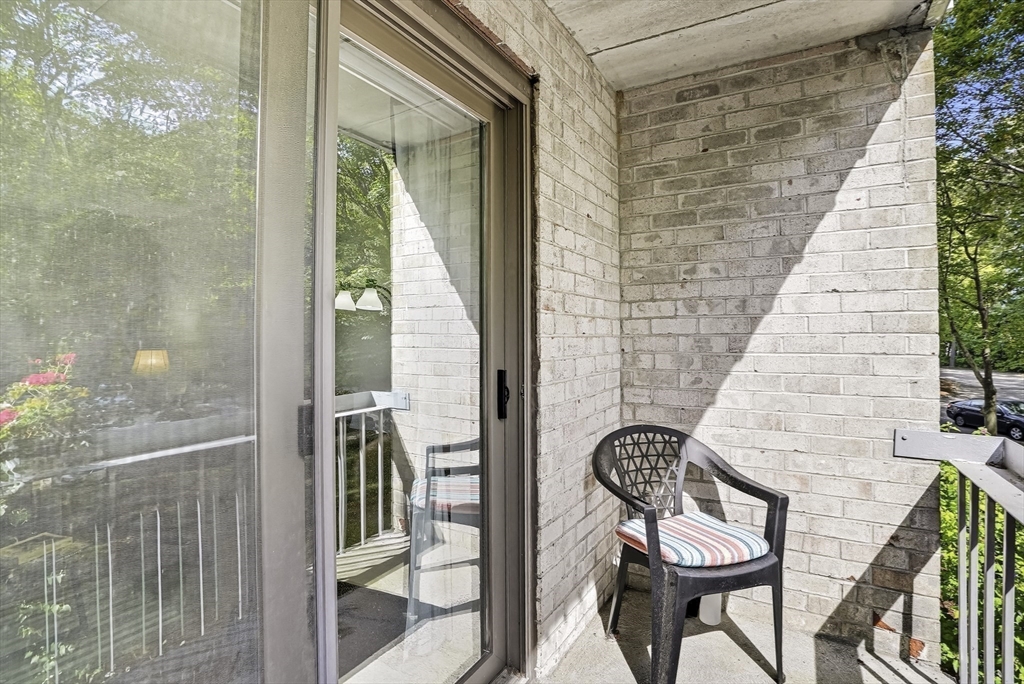 85 Commons Drive, Unit 210 Shrewsbury, MA 01545 - Photo 3 of 15 a balcony with chairs and glass door