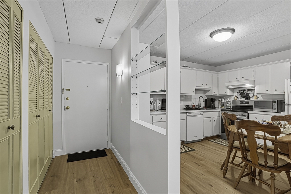 85 Commons Drive, Unit 210 Shrewsbury, MA 01545 - Photo 5 of 15 a kitchen with white cabinets and stainless steel appliances