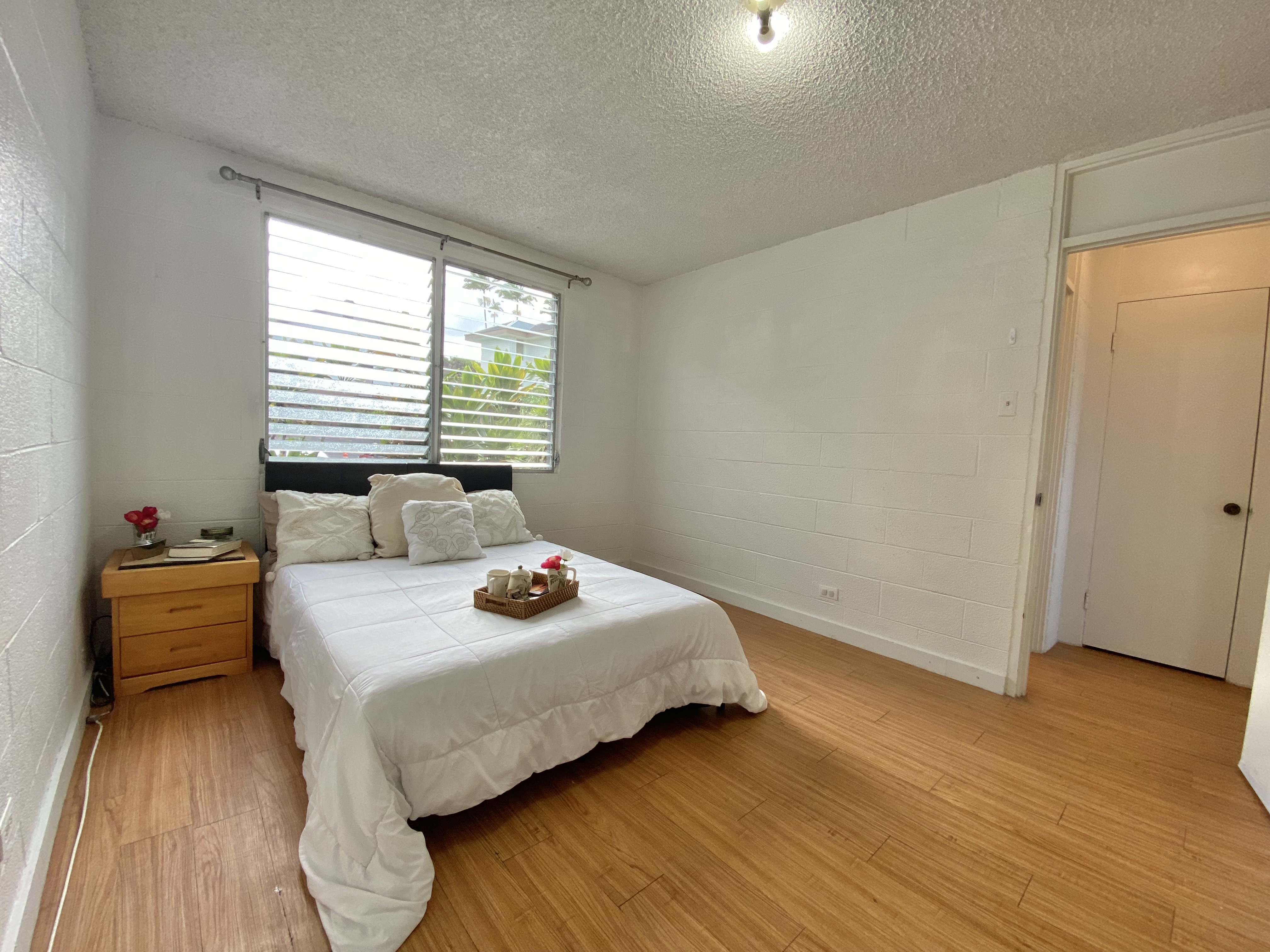 270 Ululani Street, Unit 27 Hilo, HI 96720 - Photo 12 of 19 a bedroom with a bed and wooden floor