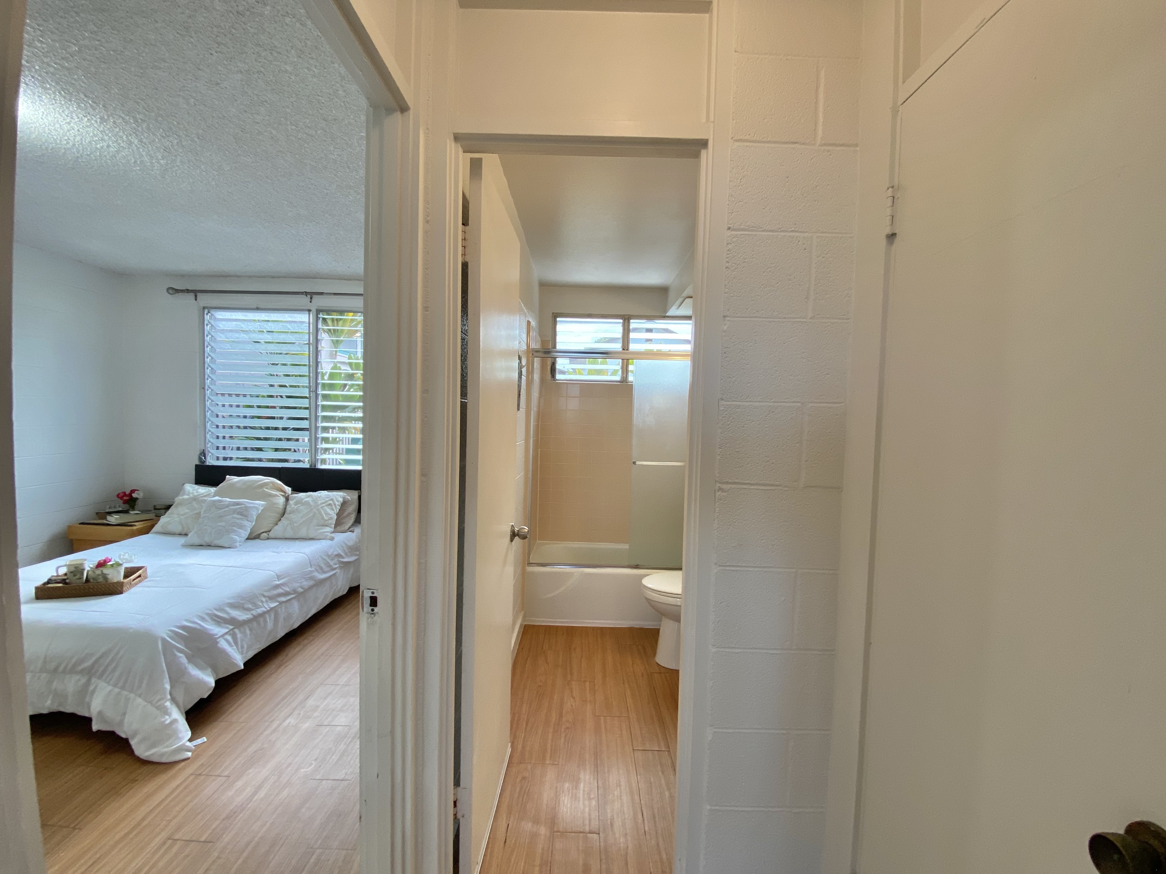 270 Ululani Street, Unit 27 Hilo, HI 96720 - Photo 13 of 19 a bedroom with a bed and wooden floor