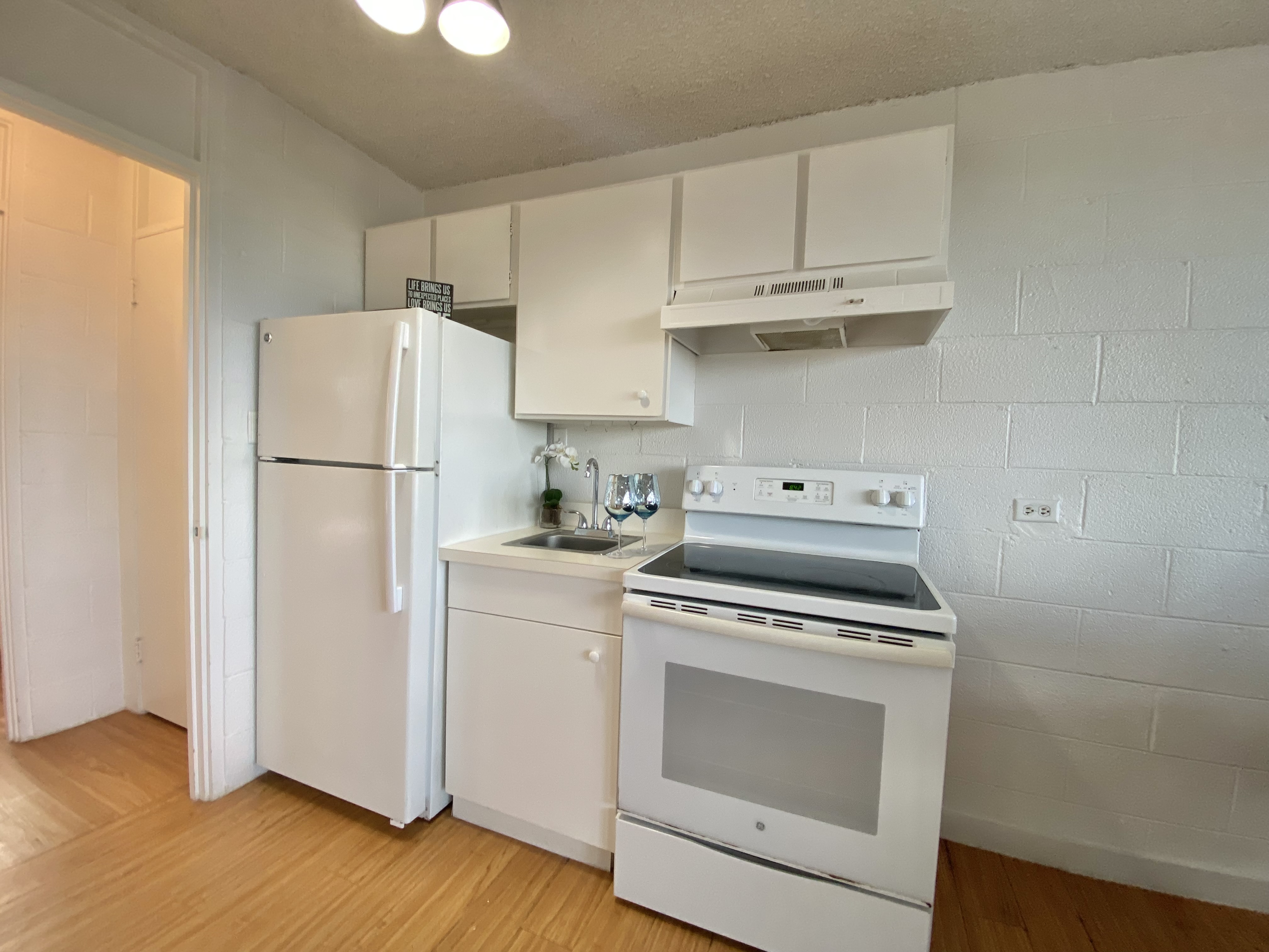 270 Ululani Street, Unit 27 Hilo, HI 96720 - Photo 8 of 19 a white refrigerator freezer and a stove sitting inside of a kitchen