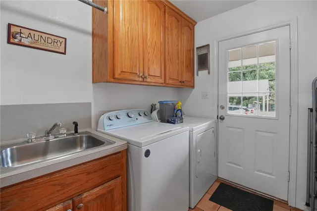 a utility room with closet dryer and washer