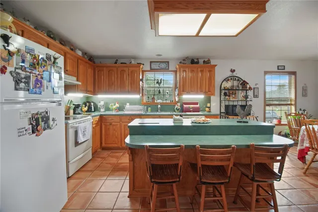 a kitchen with stainless steel appliances granite countertop a stove a refrigerator and a refrigerator