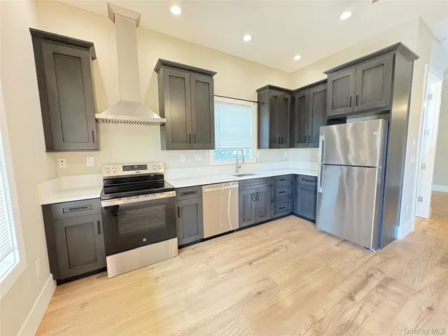 a kitchen with a refrigerator sink and wooden cabinets