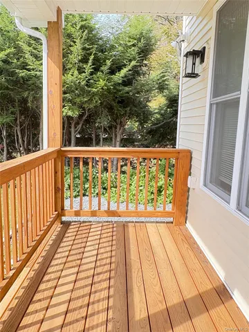 a view of a balcony with wooden floor