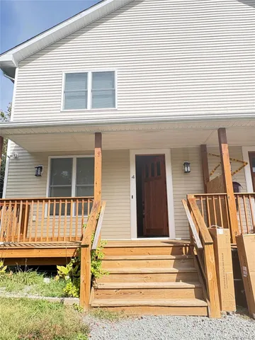 a view of a house with a small deck