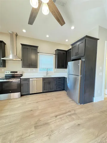 a kitchen with stainless steel appliances a refrigerator and a sink