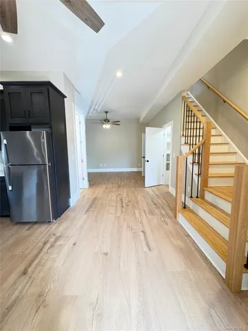 a view of a kitchen with a sink and refrigerator
