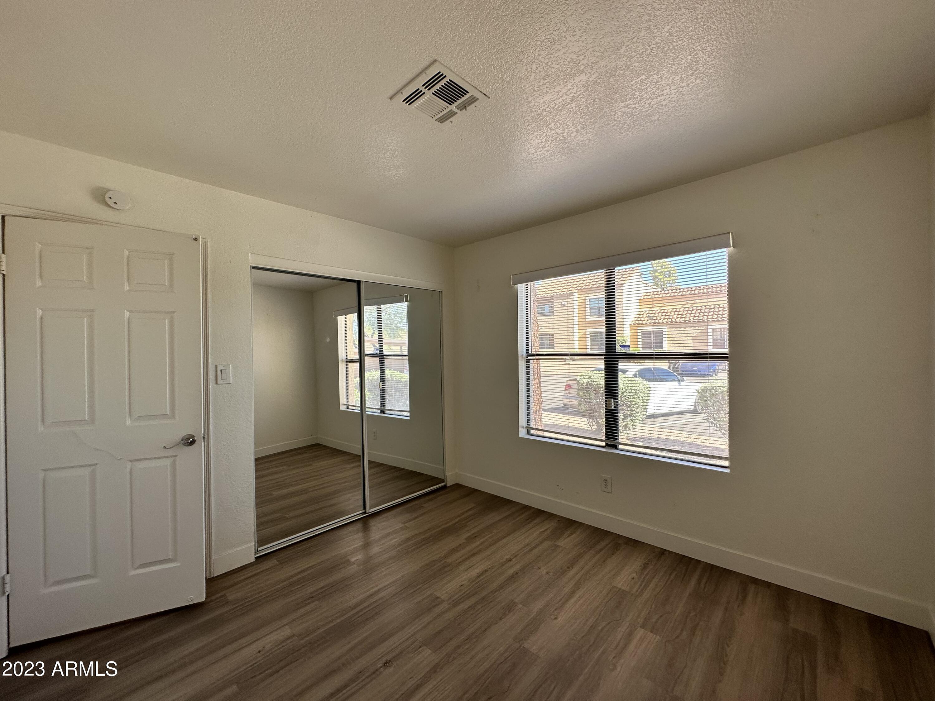 8787 East Mountain View Road, Unit 1103 Scottsdale, AZ 85258 - Photo 11 of 38 a view of wooden floor and windows in a room