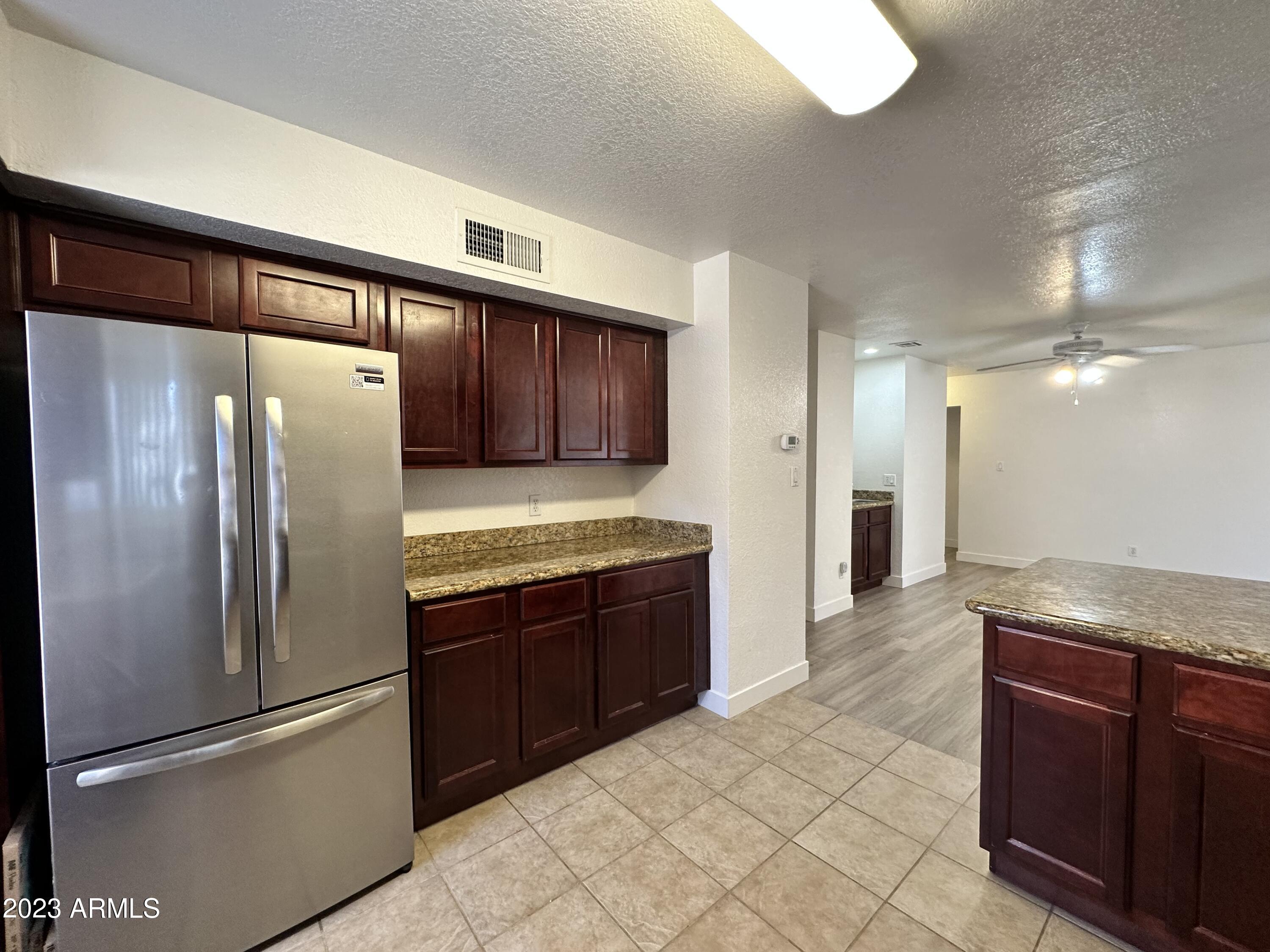 8787 East Mountain View Road, Unit 1103 Scottsdale, AZ 85258 - Photo 18 of 38 a kitchen with stainless steel appliances granite countertop a refrigerator and a sink