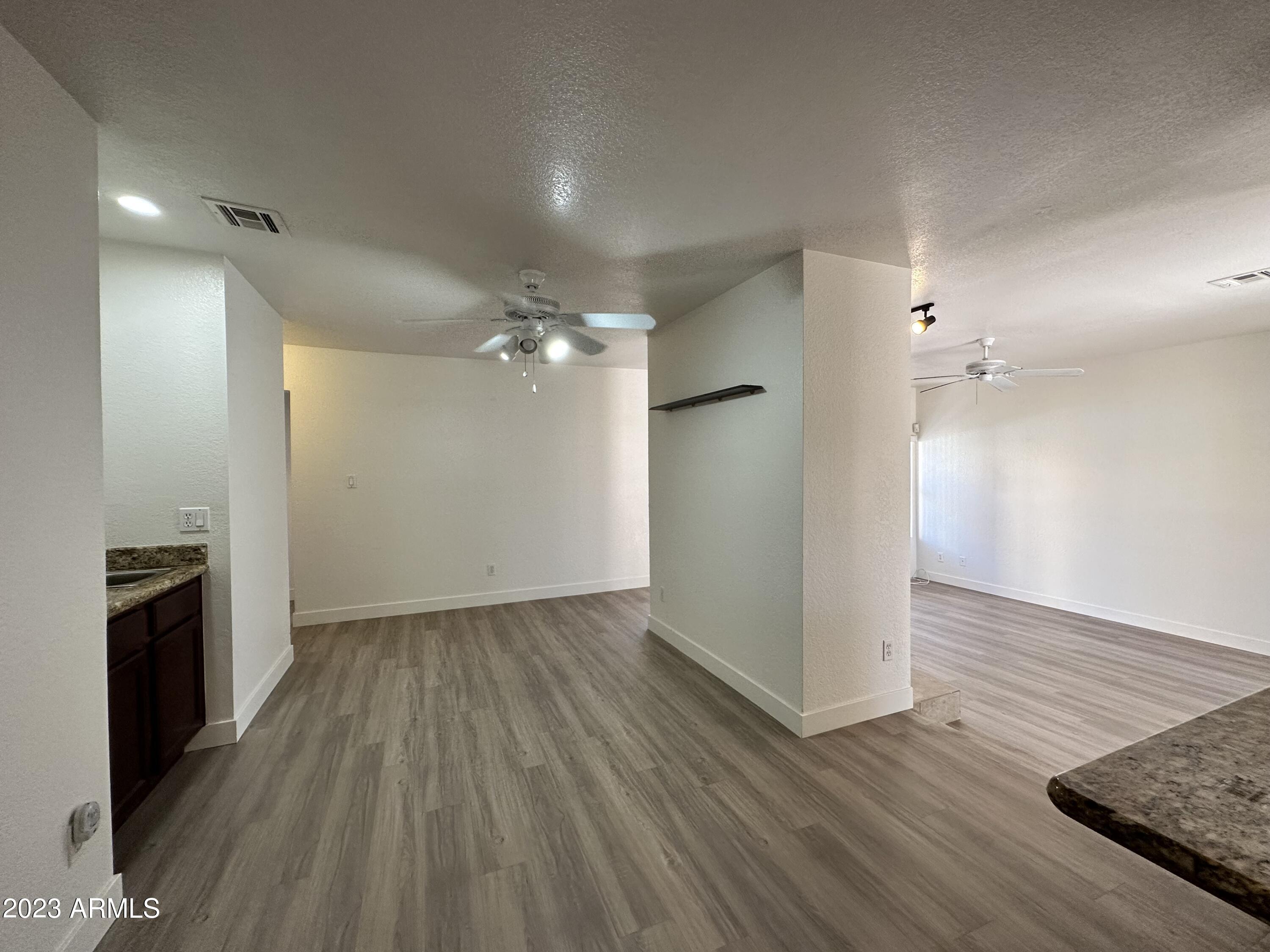 8787 East Mountain View Road, Unit 1103 Scottsdale, AZ 85258 - Photo 2 of 38 wooden floor in an empty room with a window