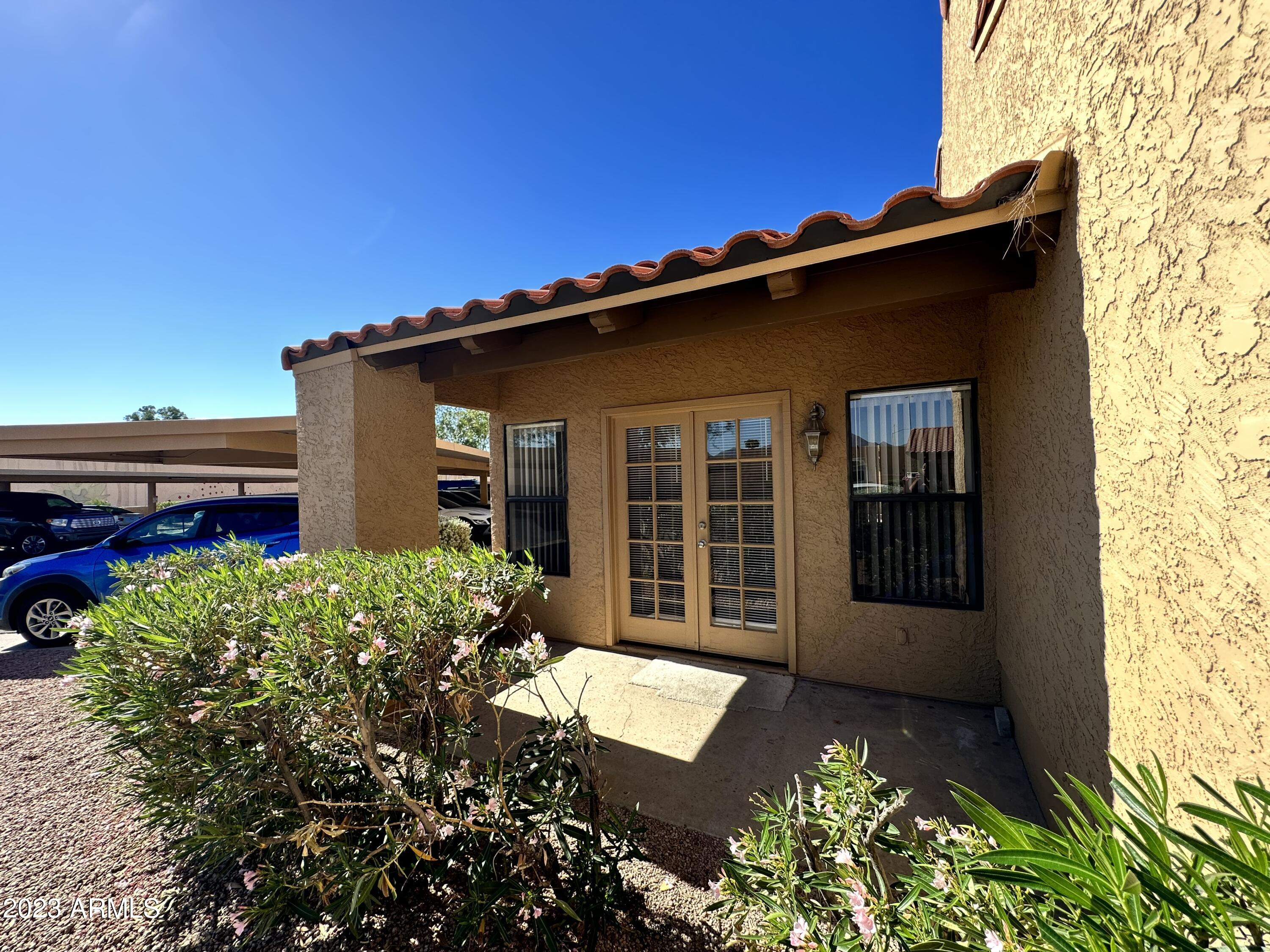 8787 East Mountain View Road, Unit 1103 Scottsdale, AZ 85258 - Photo 24 of 38 front view of a house with a yard