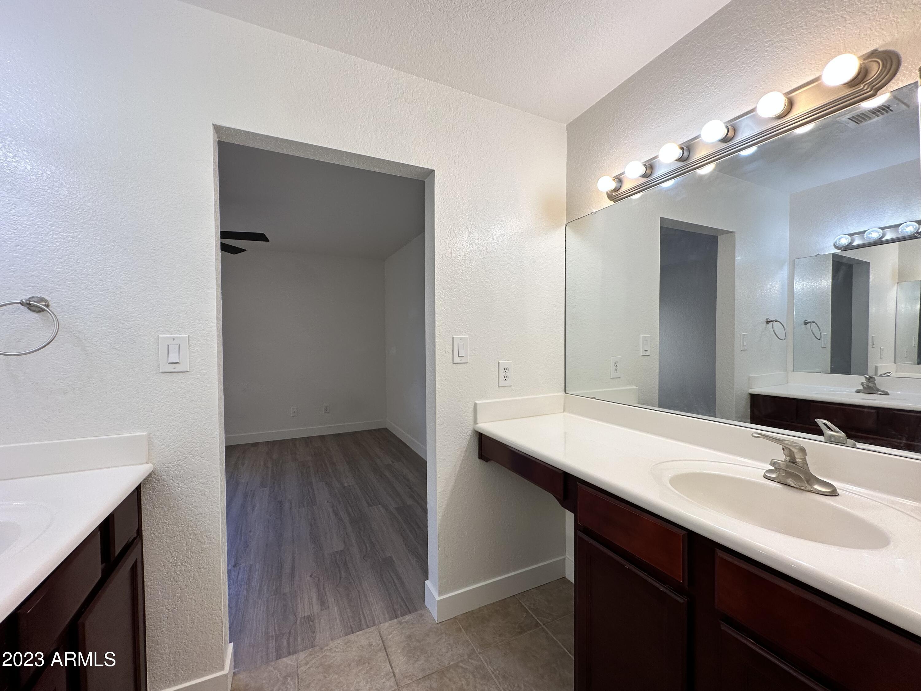 8787 East Mountain View Road, Unit 1103 Scottsdale, AZ 85258 - Photo 33 of 38 a bathroom with a sink a light fixture a vanity and a mirror