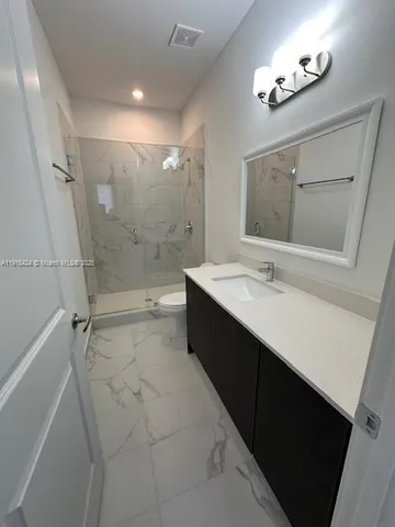 a bathroom with a double vanity sink a mirror and a bathtub