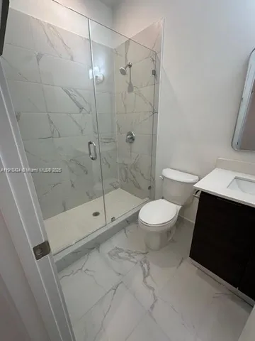 a bathroom with a shower and a toilet