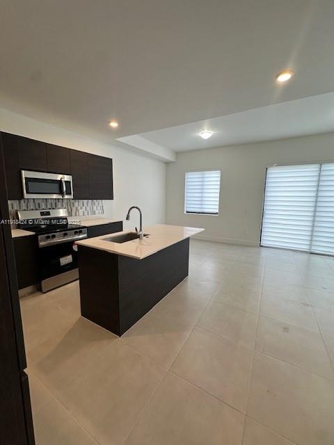 18975 Southwest 345th Terrace, Unit 18975 Homestead, FL 33034 - Photo 5 of 17 a large kitchen with stainless steel appliances a sink dishwasher stove and cabinets