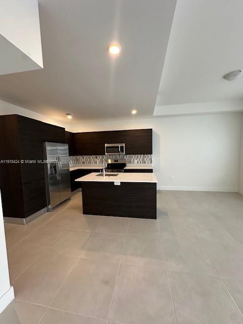 18975 Southwest 345th Terrace, Unit 18975 Homestead, FL 33034 - Photo 10 of 17 a large room with kitchen island a sink dishwasher stove and cabinets