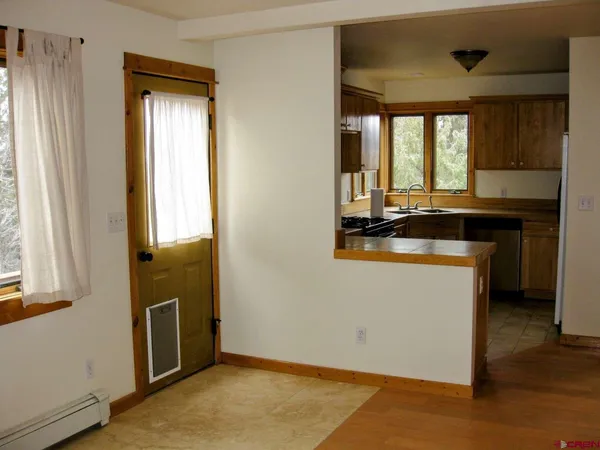 a kitchen with a window a sink and a refrigerator