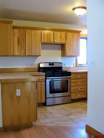 a kitchen with granite countertop a stove and a sink